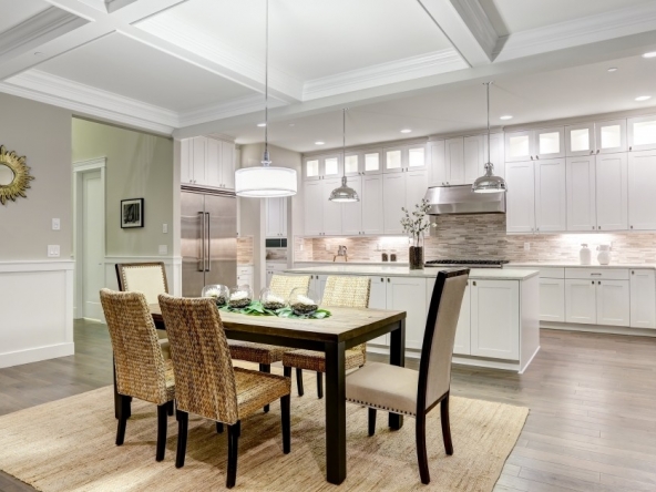 An eloquently staged dining and kitchen area.