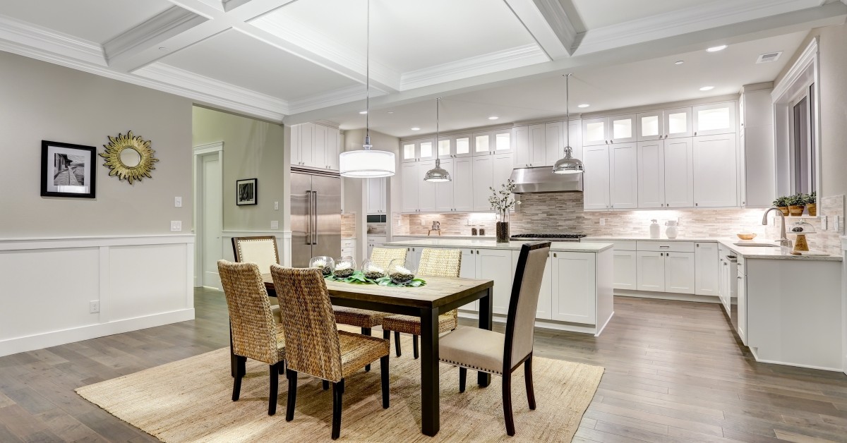 An eloquently staged dining and kitchen area.