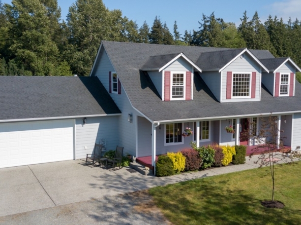 A house with a clean yard and mid-sized garage.